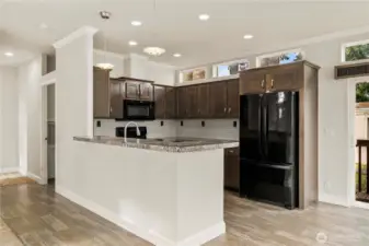 Kitchen features a spacious peninsula, ample cabinetry, and a layout designed for both function and flow.