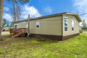 Side exterior view highlights the home’s well-maintained condition and generous outdoor space.