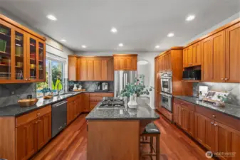 Gourmet kitchen in Horizon West home for sale in North Gig Harbor featuring cherry cabinetry, granite countertops, stainless steel appliances, and Brazilian cherry hardwood floors—an inviting space for cooking and entertaining near Downtown Gig Harbor.