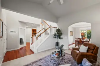 Living room in Horizon West home for sale in North Gig Harbor featuring vaulted ceilings, a gas fireplace, and Brazilian cherry hardwood floors—creating a warm, welcoming space near the entry of this gated community home.