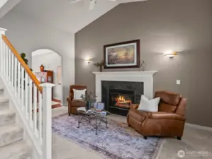 Front living room of Horizon West home for sale in North Gig Harbor showcasing vaulted ceilings, gas fireplace, and rich Brazilian cherry floors—offering timeless style and cozy ambiance in this gated community near Downtown Gig Harbor.