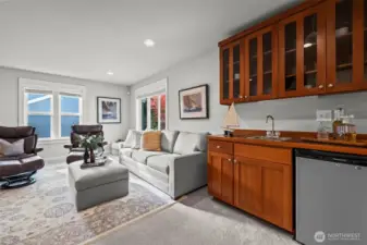 Bonus media room above the garage in Horizon West home for sale in North Gig Harbor featuring a wet bar, ample space for entertaining, and flexible use as a home theater, game room, or fitness area.