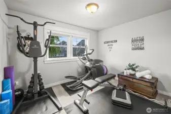 Second bedroom in Horizon West home for sale in North Gig Harbor, currently used as a home gym—versatile space with ample natural light, perfect for fitness, guest room, or hobby area.