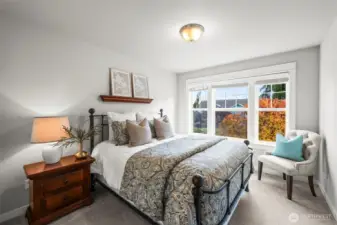 Third bedroom in Horizon West home for sale in North Gig Harbor featuring large windows overlooking the front yard, offering natural light and a comfortable space for family or guests.