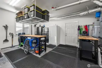 Back section of 3-car garage in Horizon West home for sale in North Gig Harbor featuring dedicated workspace and storage area—perfect for projects, tools, or hobbies in this well-equipped Northwest home.