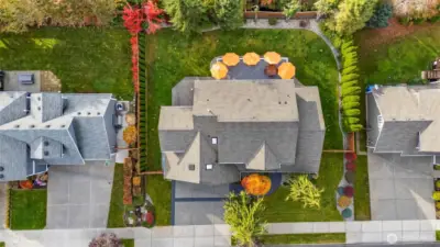 Aerial view of Horizon West home for sale in North Gig Harbor showing the property from above, highlighting the spacious lot, fenced backyard, and surrounding landscaped grounds within this gated community.