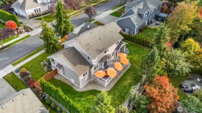 Aerial view of Horizon West home for sale in North Gig Harbor showcasing the fenced backyard, expansive Trex deck, and covered patio—ideal for outdoor entertaining and enjoying the Pacific Northwest lifestyle.