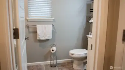 Main floor full bath provides easy access for guests and everyday living, complete with a convenient shower