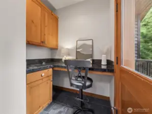 Built in nook off of the kitchen leading to exterior deck and outdoor furniture storage