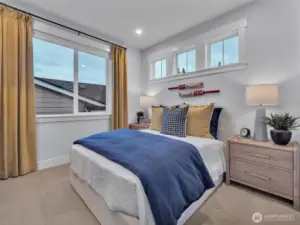 2nd bedroom showcases unique window design.