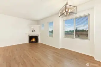 Large family room with big bright windows and new engineered hardwood flooring.