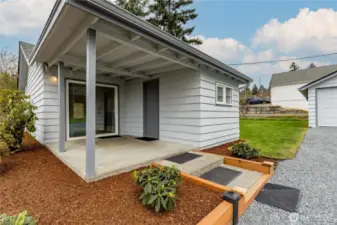 Covered back patio and newly refreshed landscaping
