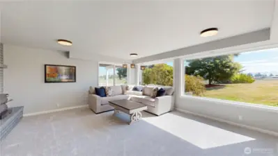 Family room offers breathtaking views of the surrounding landscape. Expansive picture windows fill the room with natural light