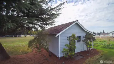 Charming detached shed versatile space for a garden shed, workshop, or extra storage area.