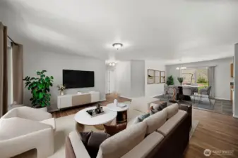 Virtually-staged living room and dining room (currently empty).