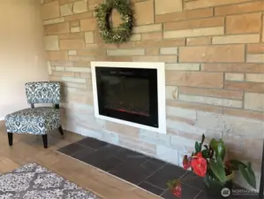 This fireplace feature is brand new in late October.  It is remote controlled, has different visual flame features & a built in 1,500 watt electric heater.