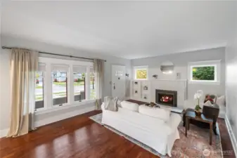 Spacious entry with soaring ceilings leads into large living and dining rooms with cozy  gas fireplace.  Original woodwork and trim, hardwood floors and vintage hardware and built ins throughout