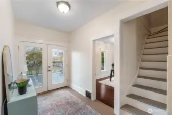Landing with French doors leads to large entertaining sized deck overlooking private backyard.  Stairs to upstairs bedrooms and bathroom