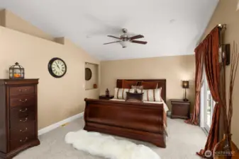 Primary suite with new carpet, walk-in closet, vaulted ceilings and a full ensuite.