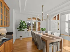 Large dining room with built-ins adjacent to the chef's kitchen and powder room.