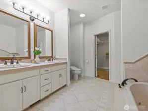 Primary bathroom showing one of two walk in closets.
