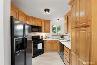 Kitchen with split sinks, durable countertops and corner windows for great light.