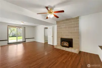 Downstairs bonus room with woodstove insert.