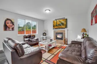 The cozy family room, warmed by a fireplace, invites relaxation.