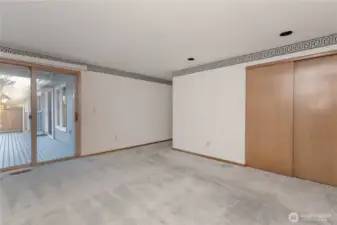 Primary bedroom with sliding door leading to the deck.