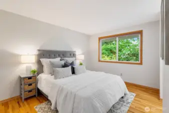 Private primary bedroom overlooking the tranquil backyard.