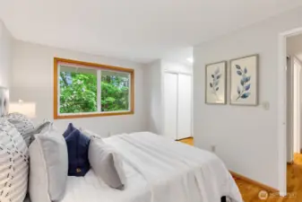 Double closets nestled between the sleeping area and full bathroom.