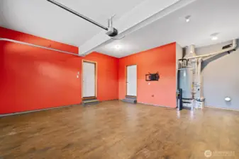 Garage with engineered hardwood flooring.