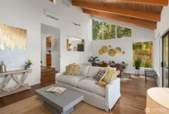 Living Room into Dinning Room - Vaulted Ceilings with Additional Windows for Added Sunlight and Greenery