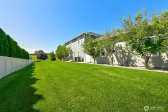 Space abounds, even at the side yard where double doors from the garage make machinery or toy access easy.