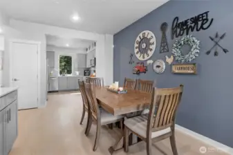 Spacious open living room, dining, kitchen, filled with natural light.