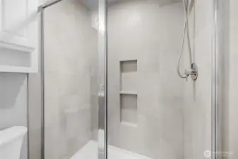 Private ensuite bathroom with modern tile.