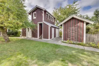 Building on right contains storage units for each cottage. Building on left is the common meeting room below with walkable deck above.