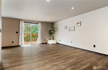 Spacious open Living room with new flooring and great deck to backyard
