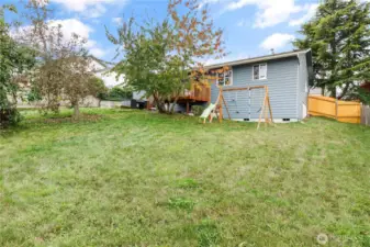 More back yard and swing set.
