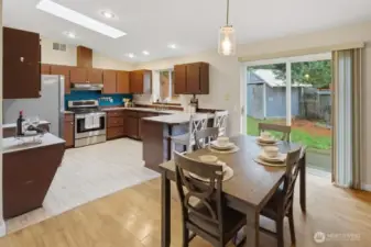 Spacious dining area with slider leading to private backyard oasis