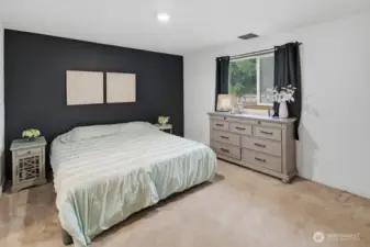 Primary Suite boasts a full ensuite bathroom and views of the backyard