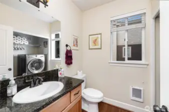 Main floor half bathroom with convenient laundry area.