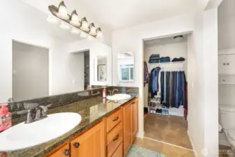 En-suite bathroom boasts dual vanity, large walk-in closet, with the water closet tucked away for privacy.