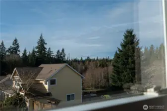 Peek-a-boo view of mountain tops from the primary bedroom