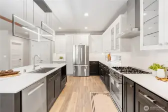 Custom kitchen sink comes complete with a cutting board, and strainers. Six-burner natural gas Bosh stove.