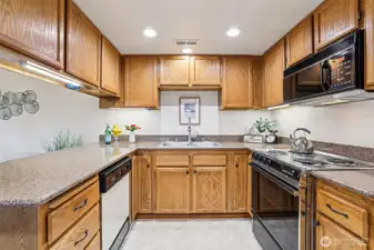 Friendly chef kitchen with solid surface countertops and easy flow.