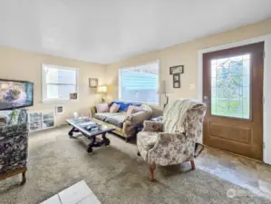 The nicely sized living room is filled with natural light, offering a bright and welcoming space with a lovely view of the front yard