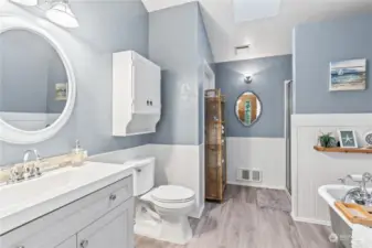 The beautifully updated bathroom features a New Vanity, Fixtures and Lighting. Notice the Skylight!