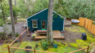 Image of backyard, fencing, back deck. Kayaks hanging on fence are included, if you'd like!