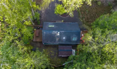 Overhead view showing the composition roof, shed, decks and driveway.